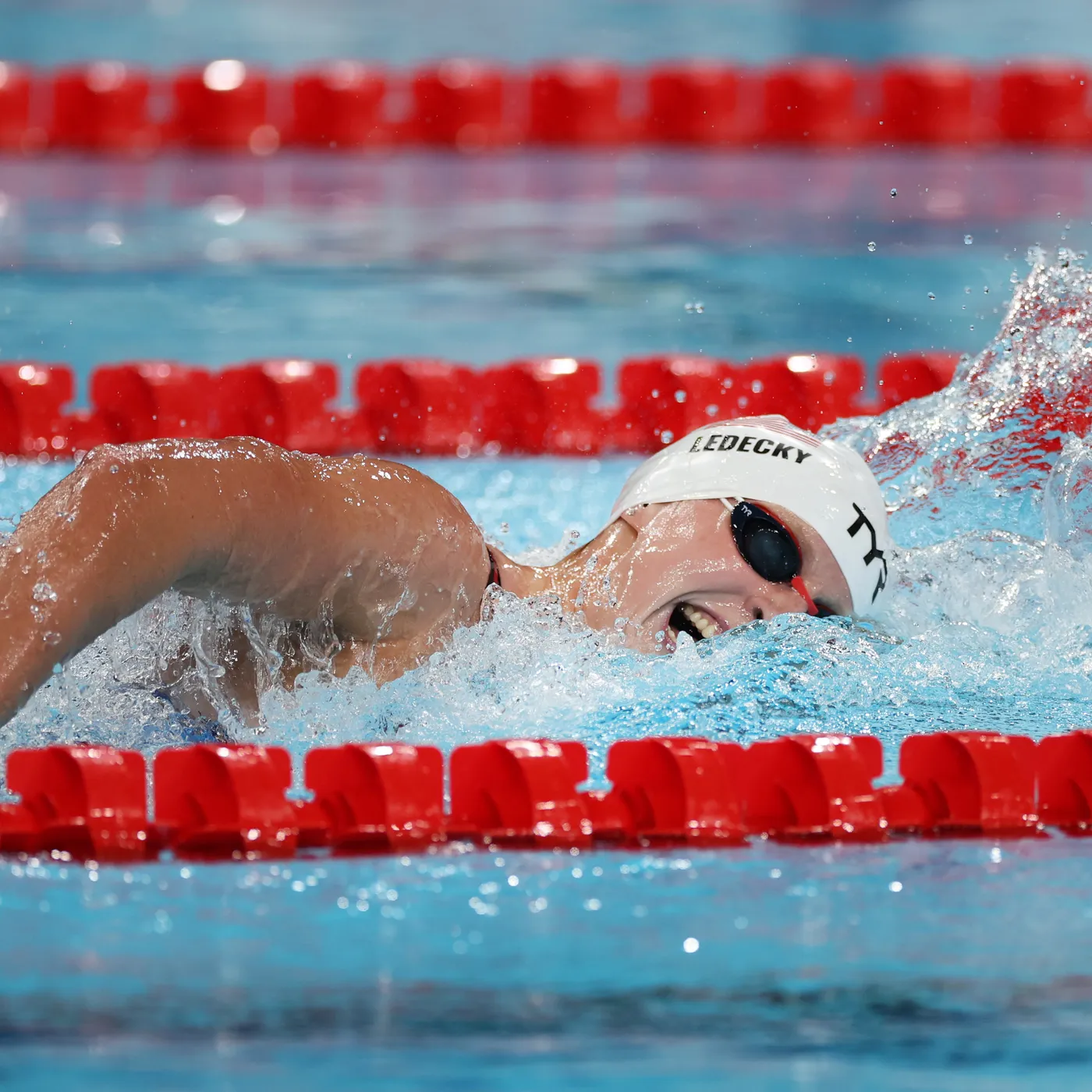 Feet with fins kicking underwater in a clear pool.